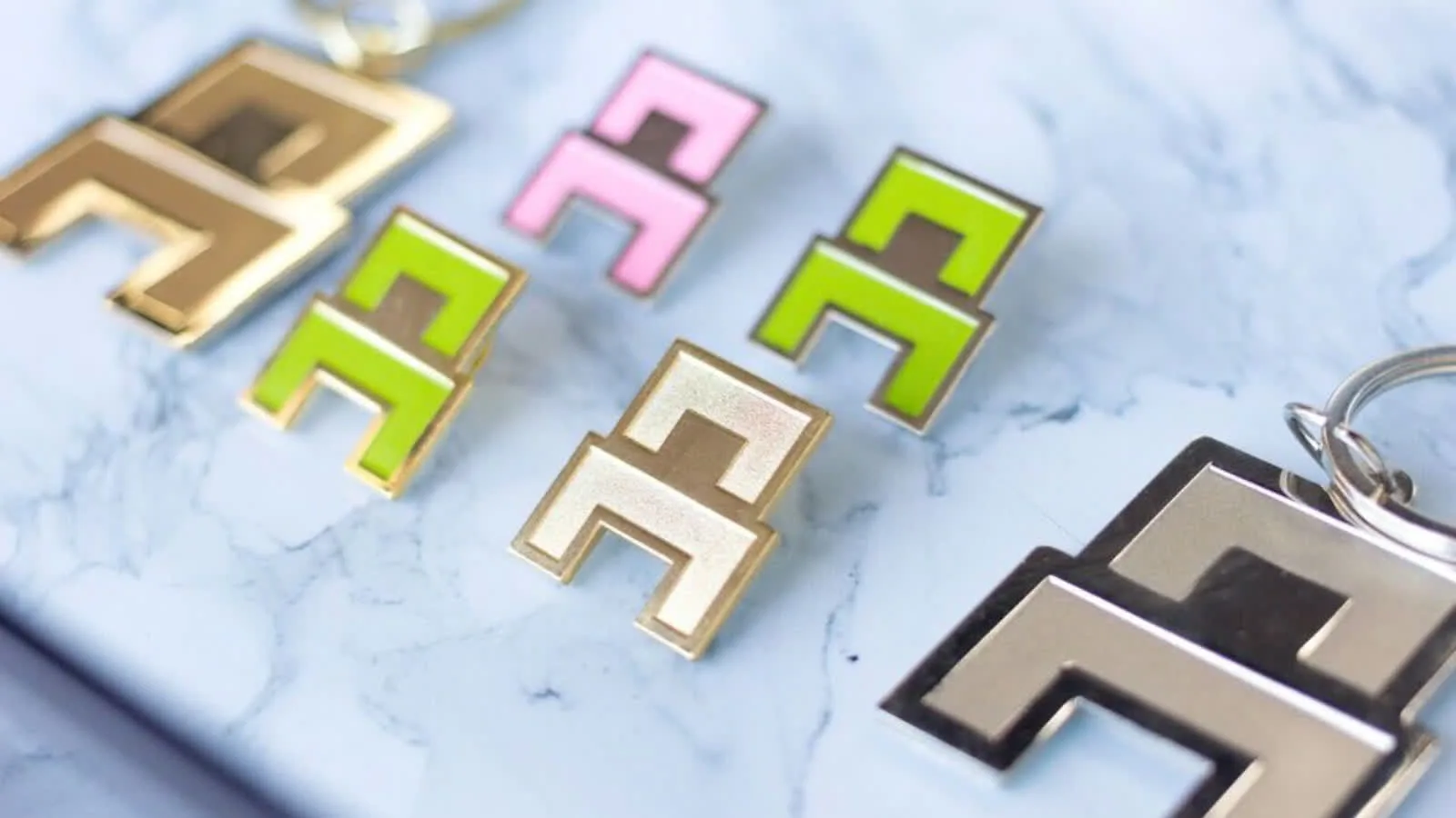 Chair branded pins and keychains on marble